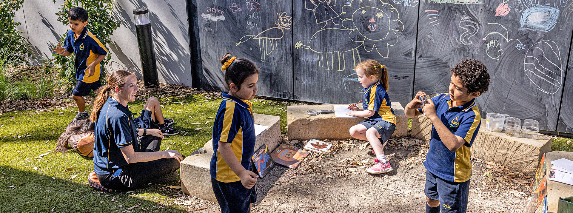 St Josephs Catholic Primary Kingwood teacher playing with students outside