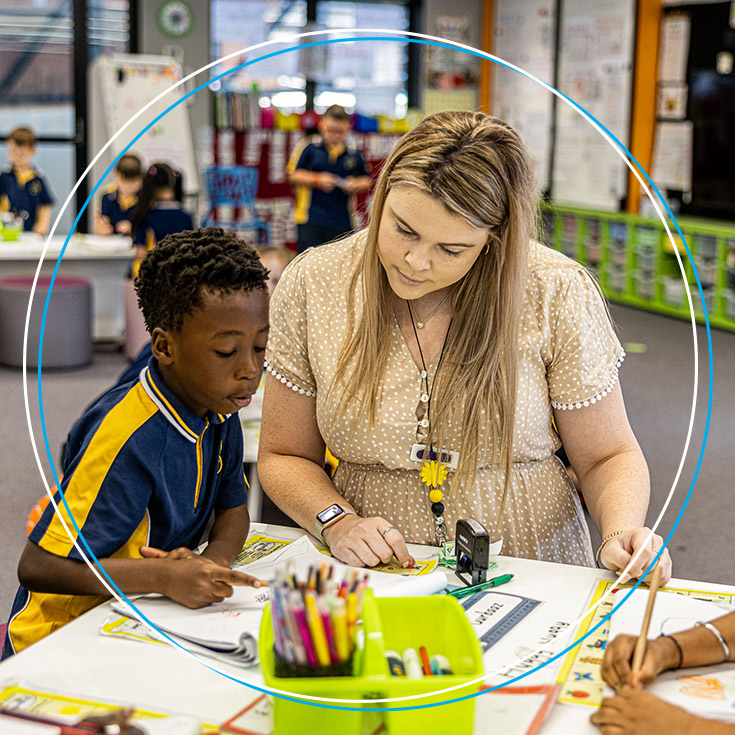 Teacher supporting student at St Josephs Catholic Primary Kingwood