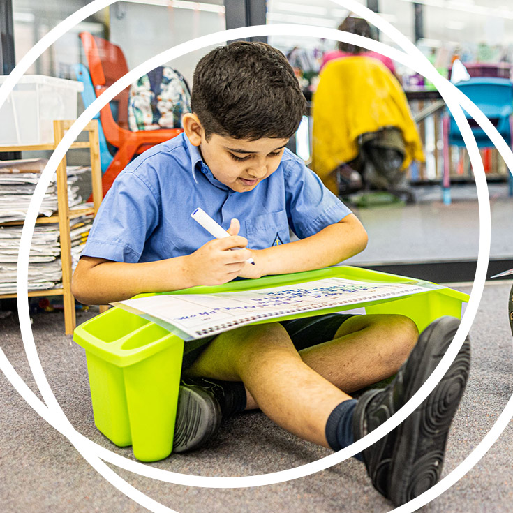 Boy with modular desk at St Josephs Catholic Primary Kingwood