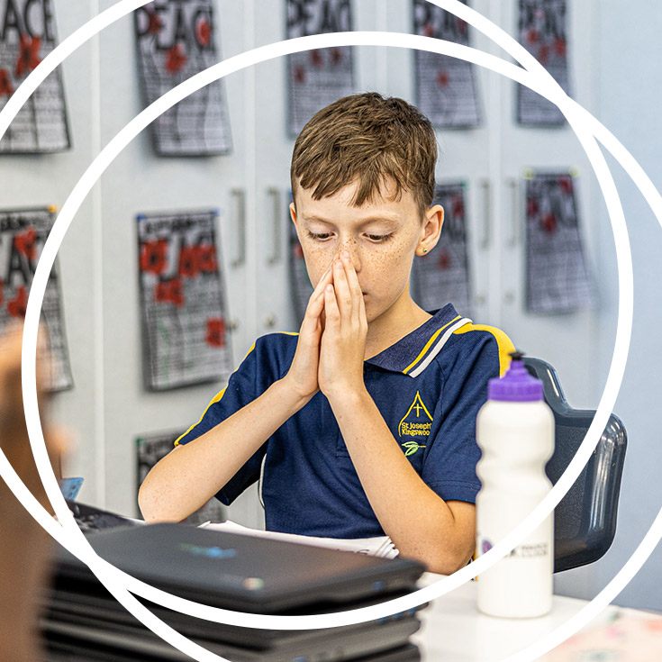 Boy praying at St Josephs Catholic Primary Kingwood